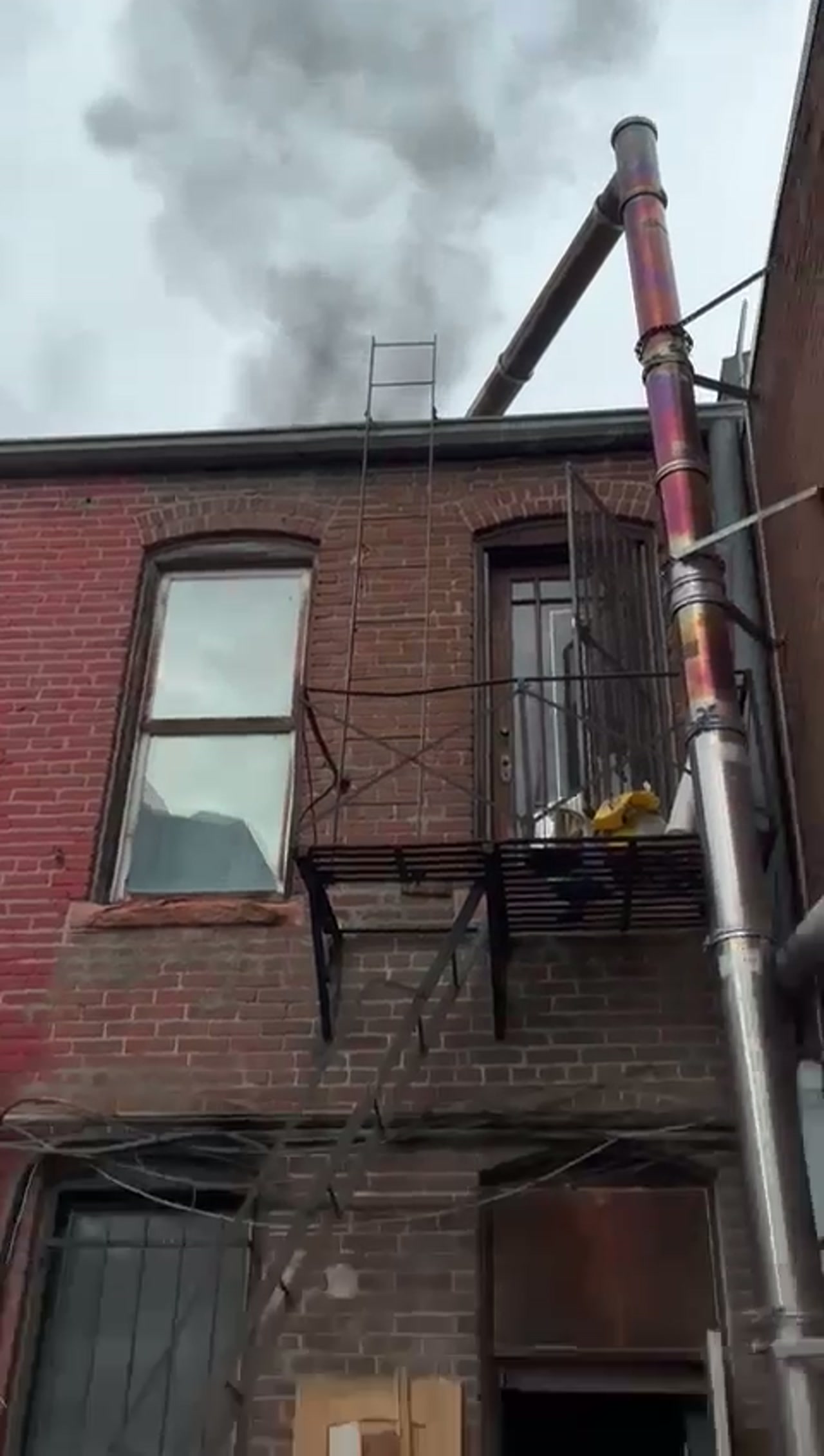 Adam Chimney Sweep tracing smoke from a brick building chimney flue in Denver