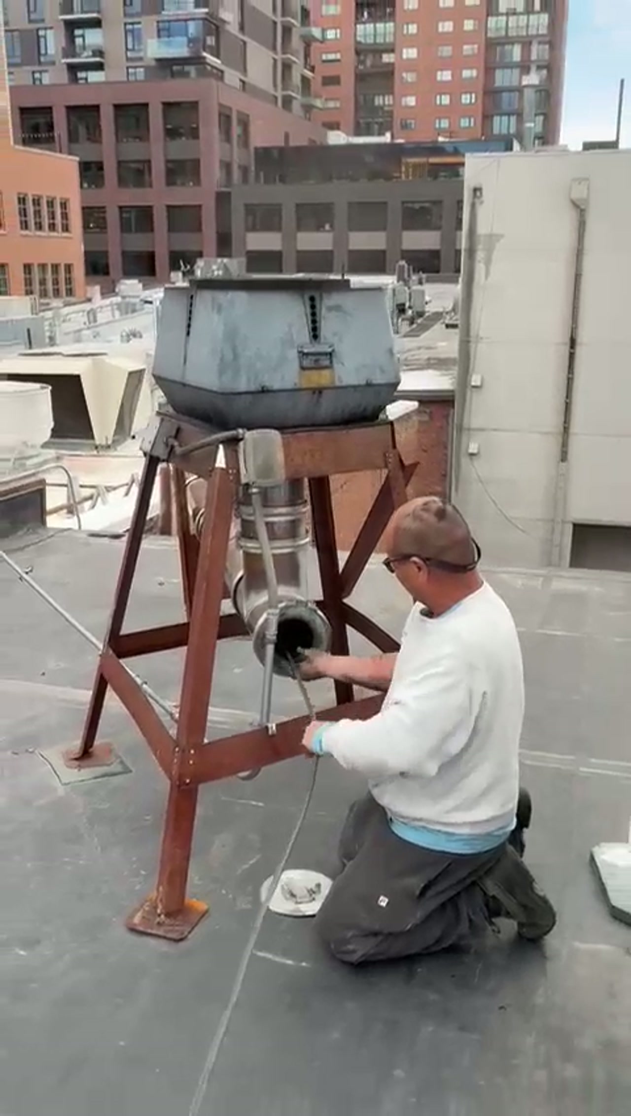 Adam Chimney Sweep power-sweeping a commercial pizza oven rooftop flue in Denver