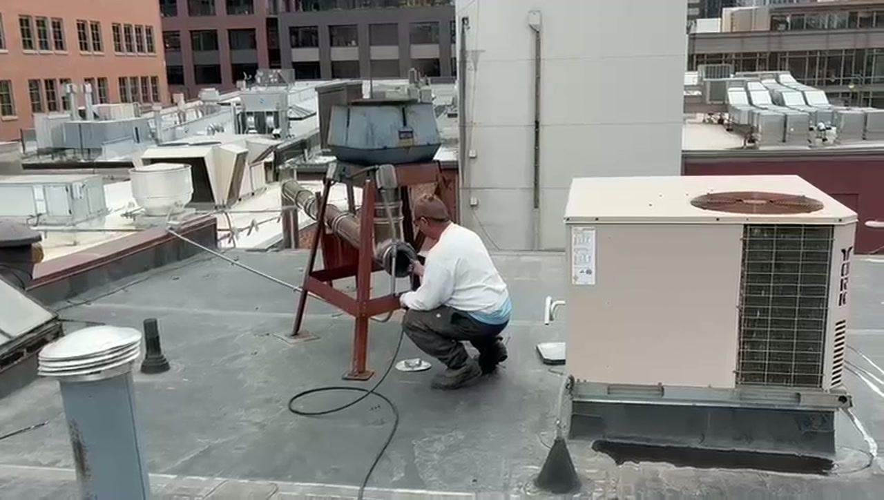 Soot removal Adam Chimney Sweep removing soot from a commercial pizza oven exhaust flue in Denver