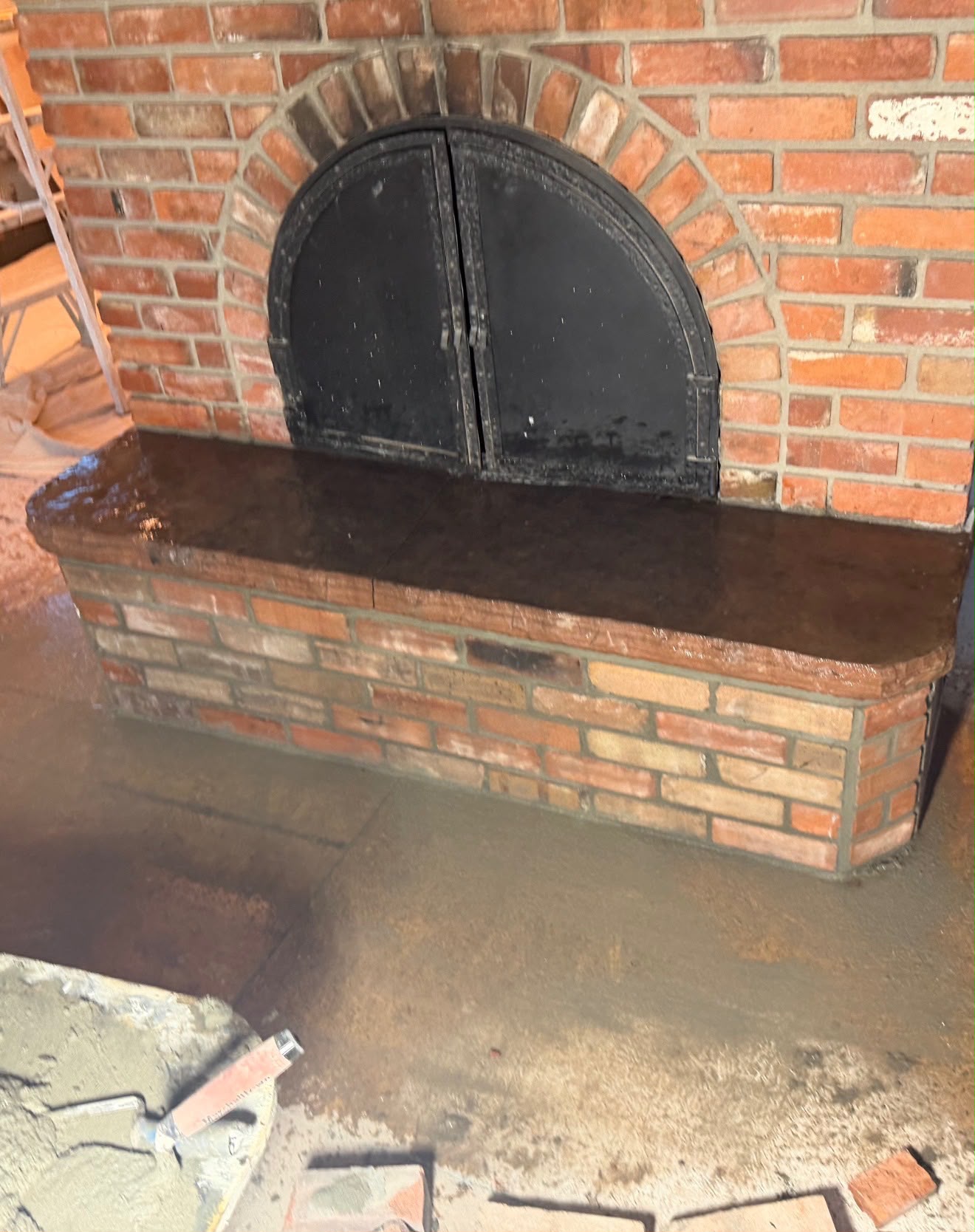 Close-up of fireplace hearth stone cap and new masonry joints during repair